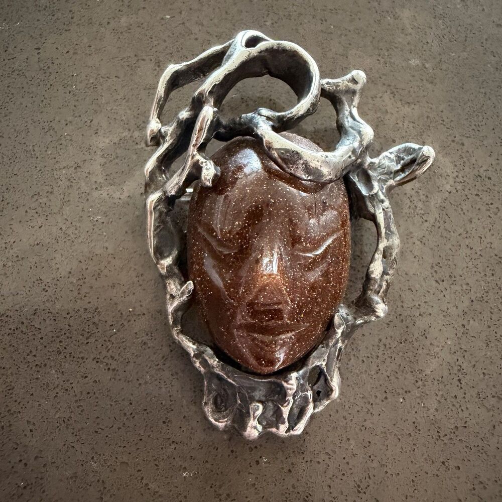 Carved Goldstone Face Surrounded By Brutalist Sterling Silver Brooch Pin